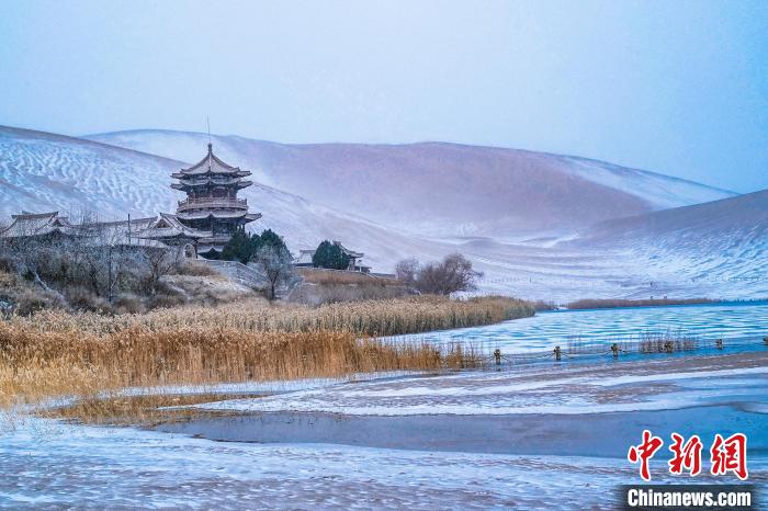 2021年11月28日，雪落鳴沙山月牙泉景區(qū)?！⊥醣筱y 攝