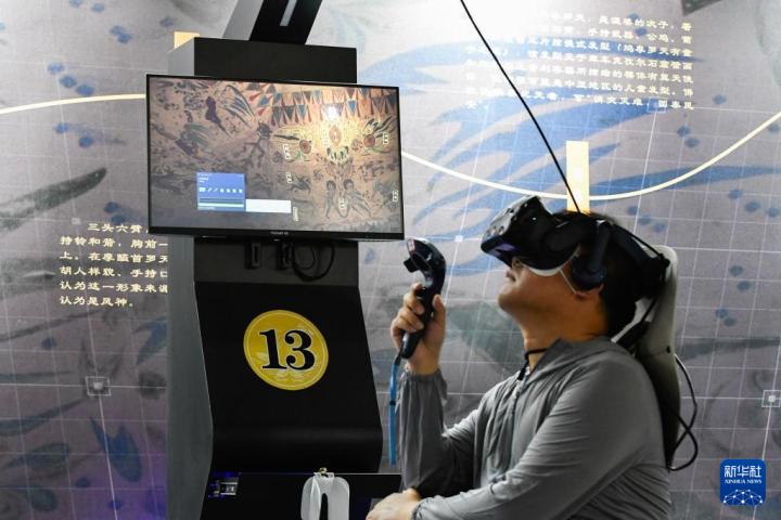 7月22日，游客借助VR設備沉浸式游覽莫高窟第285窟虛擬場景。新華社記者 郎兵兵 攝